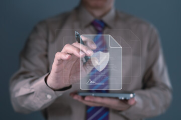 Digital document protection and secure online signature concept with shield icon and businessman using stylus on tablet