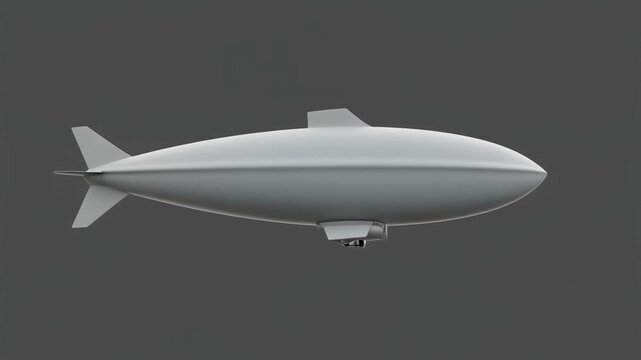 A sleek grey blimp or airship with a streamlined design, viewed from the side against a solid dark background.