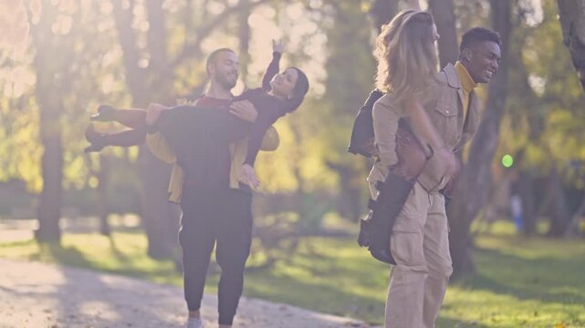 Four diverse young friends enjoy a cheerful day in a park. - Powered by Adobe
