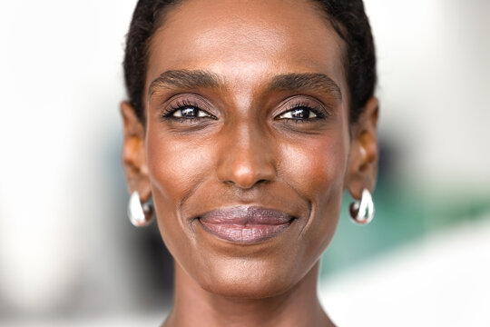 Close up facial portrait of African woman looking at camera