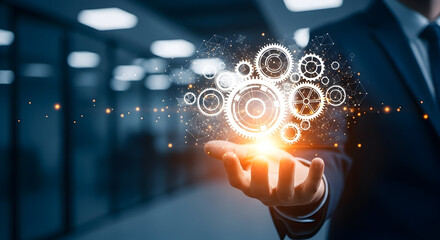 Businessman holding digital gears in hand representing technology innovation and business solutions with glowing particles