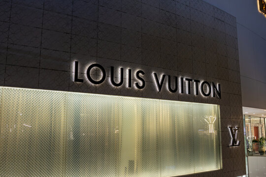 Bangkok \ Thailand - 10 November 2025: Illuminated Louis Vuitton storefront with a patterned facade at The Emporium mall
