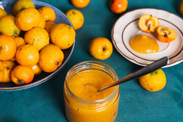 Quince fruit jam in a jar with fresh whole fruit