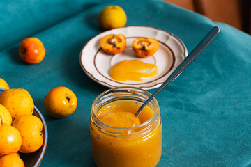 Homemade quince jam on spoon with fresh fruit