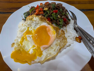 Pad Kra pao a fried egg on top of rice, Thai food, street food Thai
