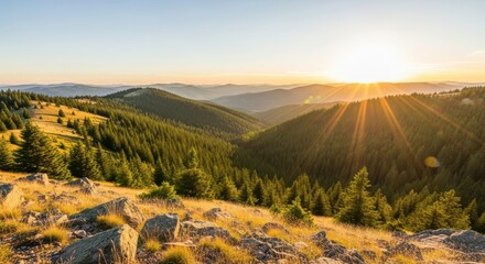 Golden hour sunburst over rolling forested mountain range at sunset or sunrise, showcasing a vast, tranquil landscape with sun rays shining through the clear sky