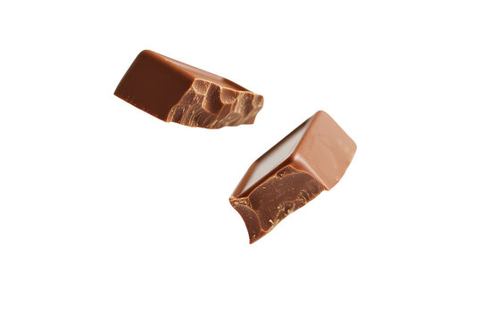 Two pieces of chocolate bar suspended in mid-air against a white background. emphasizing their smooth texture and rich color. ideal for food-related content