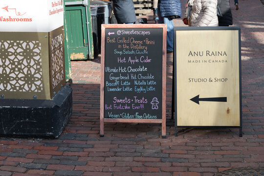 sidewalk signs for The Sweet Escape and Anu Raina located at 24 Tank House Lane, Distillery District, Toronto