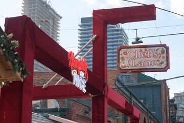 Fototapeta premium Chef's Lane (Naughty or Nice) at The Distillery Winter Village 2025, 55 Mill St, The Distillery Historic District, Toronto