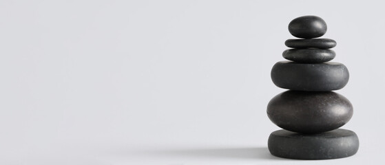 Stack of pebbles on grey background. Zen concept