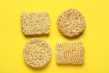 Raw instant noodles on yellow background