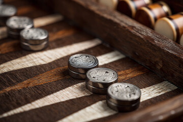 Players engage in a strategic game of backgammon on a beautifully crafted wooden board during a cozy evening at home