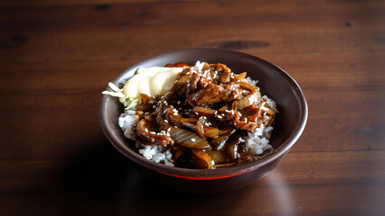 cooked homemade tasty spicy beef yakiniku seasoned sliced beef meat with condiment and warm rice served in black bowl