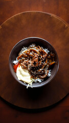 cooked homemade tasty spicy beef yakiniku seasoned sliced beef meat with condiment and warm rice served in black bowl