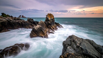 Long exposure coastal scene, waves crashing on weathered rock formations