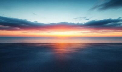 Serene ocean horizon at sunset with vibrant orange and pink sky reflecting on calm water under soft blue clouds