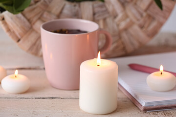 Wax burning candles on table