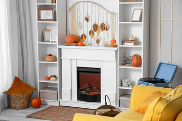 Fototapeta premium Interior of living room with pumpkins, fireplace and shelf units