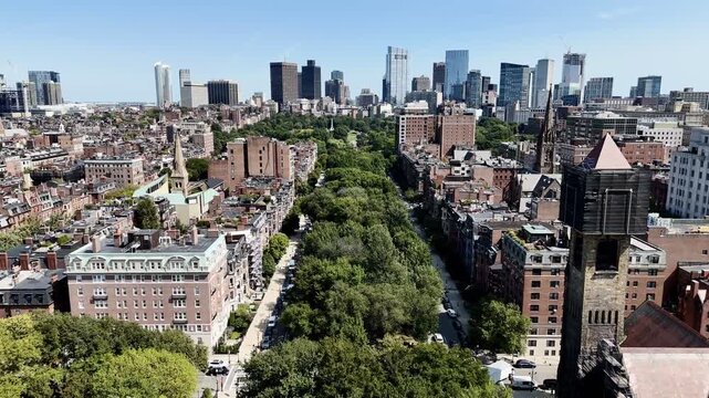 Aerial view of Boston downtown skyline with skyscrapers, historic church and green park avenue on sunny day. gg