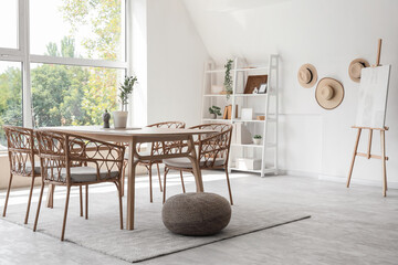 Interior of dining room with table, shelf unit and easel