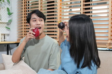 The couple watches TV together in the living room in the morning