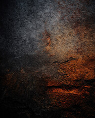 Dark grunge plaster wall close-up with black and rust tones — high-detail moody industrial texture background