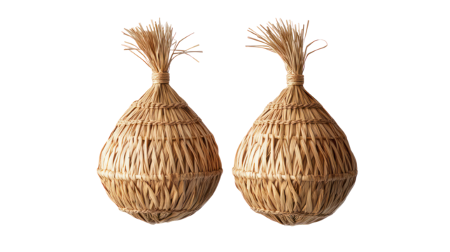 Pair of traditional handmade straw ornaments overhead side by side on transparent background