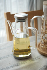 cooking oil in a glass jar on a table 
