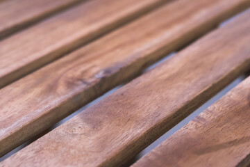 Fototapeta premium Warm brown wood plank background with natural texture and grain. simple, calming parallel board pattern works well for flooring, decking or furniture design concepts