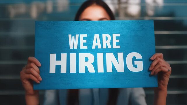 We are hiring announcement by a beautiful woman, new job opportunities in a modern company, human resources department is expanding, recruitment campaign