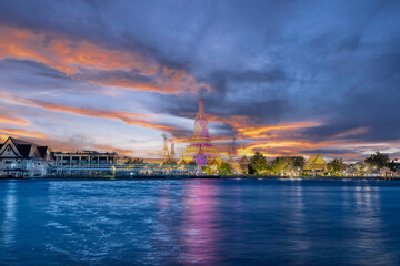 Fototapeta premium 26 November 2025 Beautiful Sunset colours of Thai Temple Wat Arun on Chao Phraya River in BKK Bangkok Thailand. The magic colourful neon light display on the temple at sunset is magical.