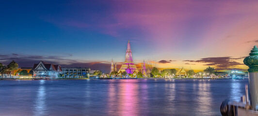 26 November 2025 Beautiful Sunset colours of Thai Temple Wat Arun on Chao Phraya River in BKK Bangkok Thailand. The magic colourful neon light display on the temple at sunset is magical.