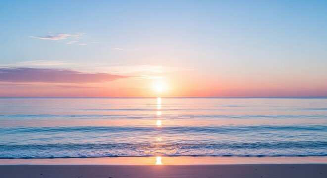 Serene ocean sunrise or sunset over calm water with gentle waves reaching a sandy beach, featuring soft pastel colors in the sky reflecting on the sea surface