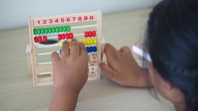 Child learning math with colorful abacus at home