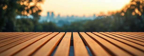 wooden slatted tabletop in foreground with blurred trees and distant city skyline at golden hour, tranquil warm sunset atmosphere