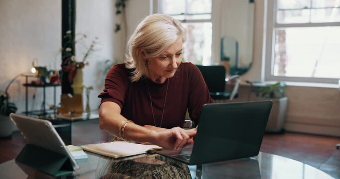 Woman, laptop and salon manager with writing notes, book and checklist with inventory management at shop. Mature person, tech and computer on point, search and review appointment schedule at parlor