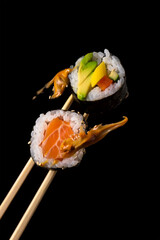 Fresh Japanese sushi roll with salmon with chopsticks