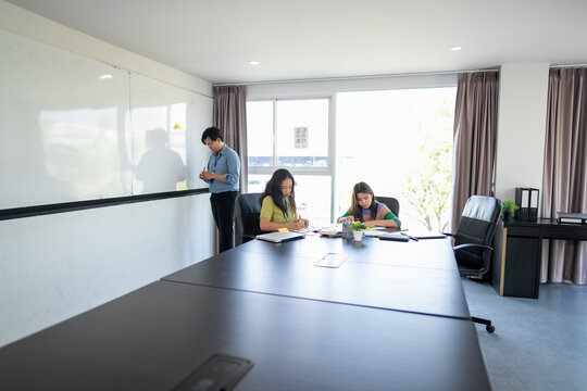 Young Business Professionals Collaborating on a Business Project in a Meeting Room.