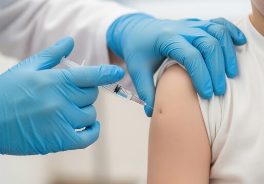 Child receiving vaccine injection from medical professional in blue gloves