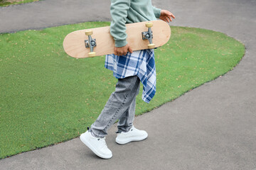 Young man with skateboard at skatepark