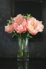 Peonies in glass vase.