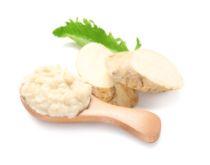 Wooden spoon with horseradish sauce, leaf and slices on white background