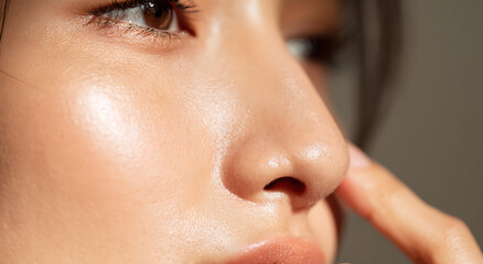 Close up of a woman touching her smooth skin for skincare and beauty care
