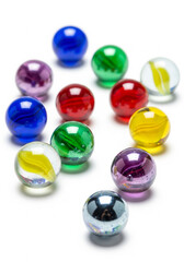 Fototapeta premium Collection of colorful glass marbles shiny and vibrant arranged on a white surface