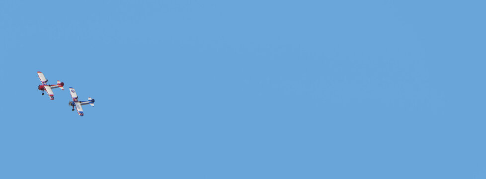 AeroSuperBatics Wingwalkers G-IIIY N-5057V Aviation displays Airwaves Air show Portrush N Ireland blue sky background for text copy 7-5-24