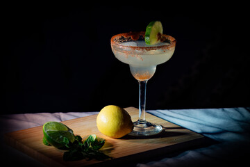 Margarita on cutting board with black background