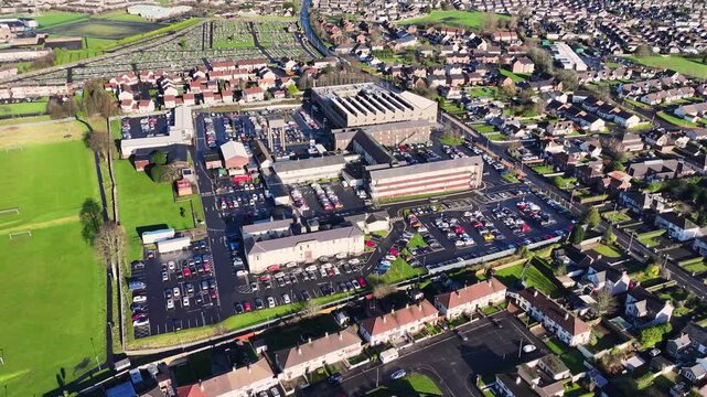 Aerial view of A55 Kennedy Way & Anderson Way Crossroads at Westwood retail park Belfast City Northern Ireland at night 27-01-25 