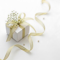 A beautifully wrapped gift box adorned with a golden ribbon and delicate floral accents, set against a clean white backdrop.