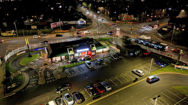 Aerial view of McDonald's Fast food restaurant at Westwood retail park Belfast City Northern Ireland at night 21-01-25
