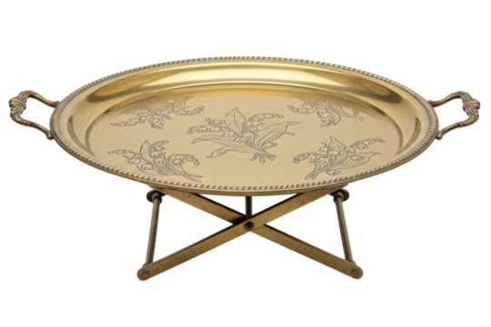 Golden brass serving tray with floral engraving on folding stand isolated on transparent background